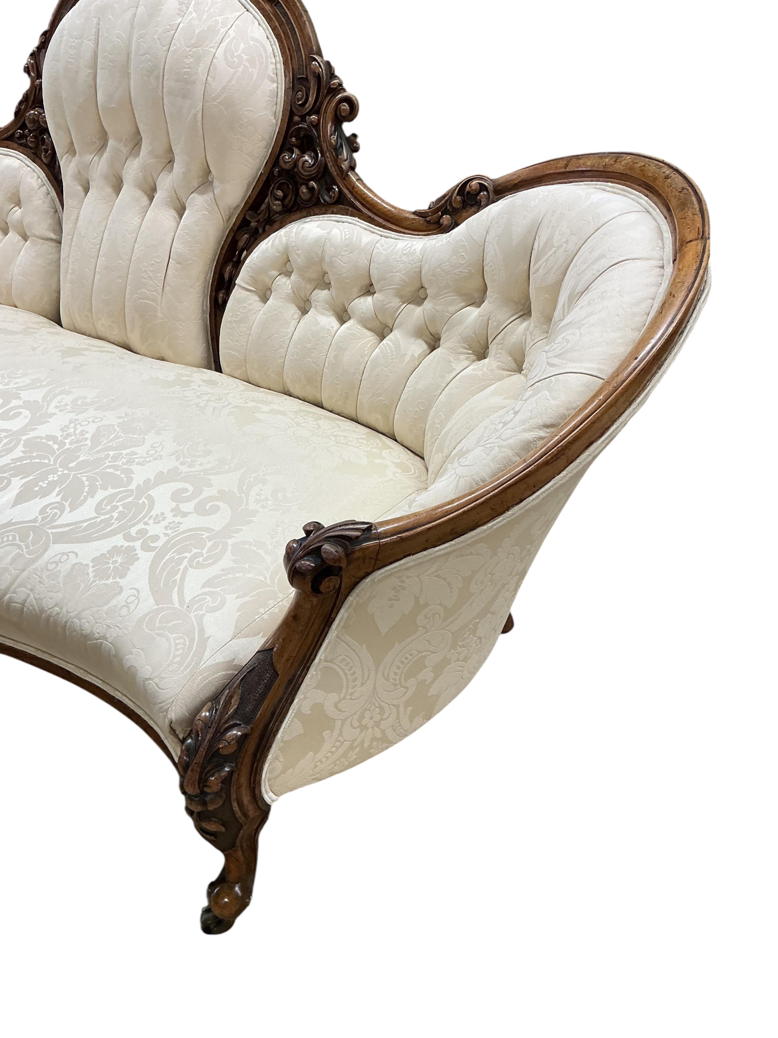 A Victorian carved mahogany walnut double spoon back settee, width 198cm, depth 79cm, height 101cm